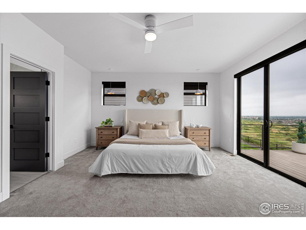 2145 Picture Point Drive Windsor, CO 80550 - Photo 12 of 40 a bedroom with a large bed and a large window