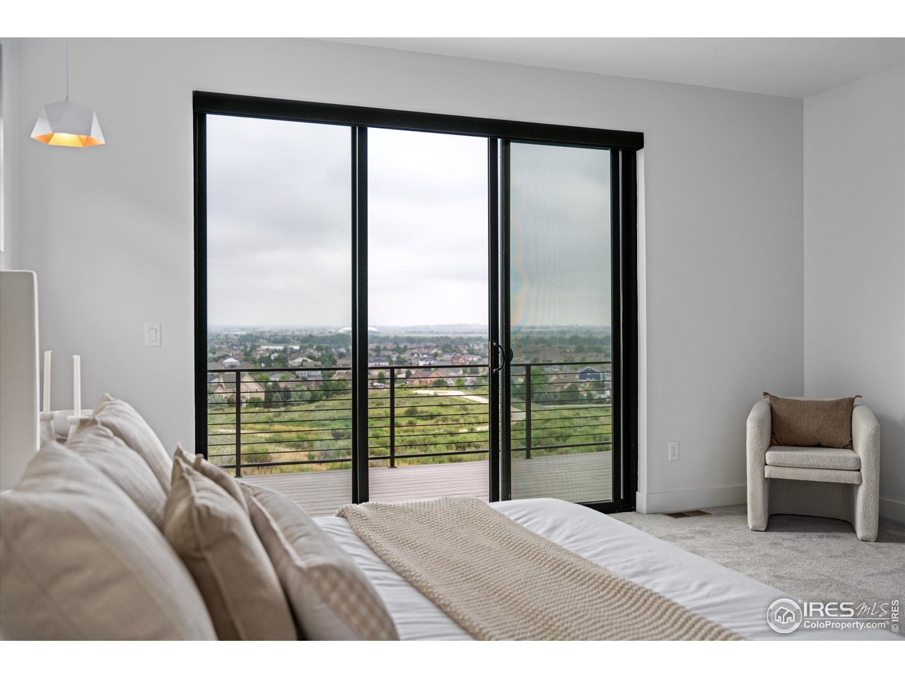 2145 Picture Point Drive Windsor, CO 80550 - Photo 14 of 40 a bedroom with a bed and glass window