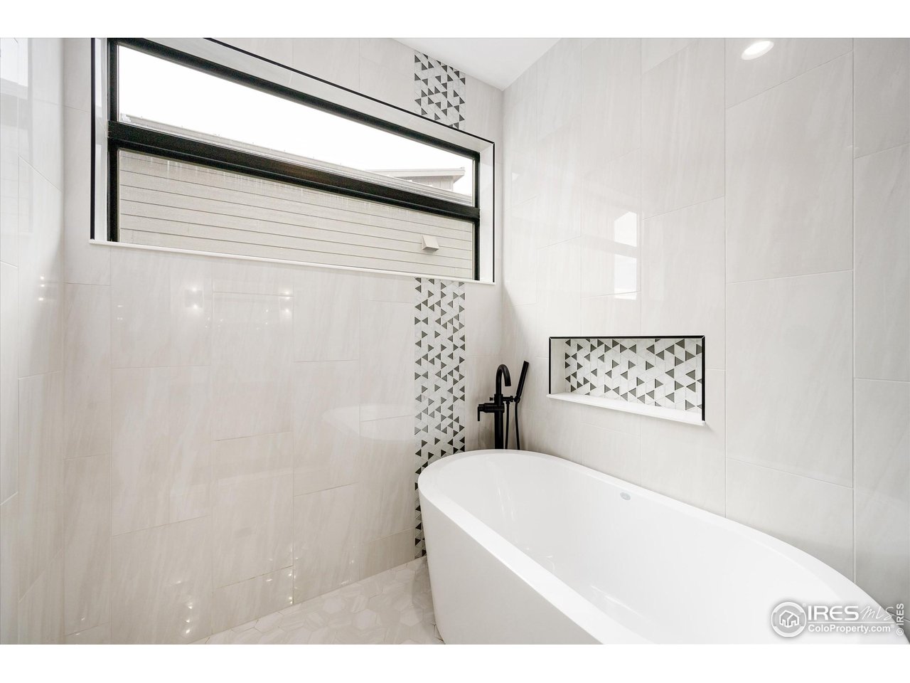 2145 Picture Point Drive Windsor, CO 80550 - Photo 17 of 40 a bathroom with a bathtub and shower