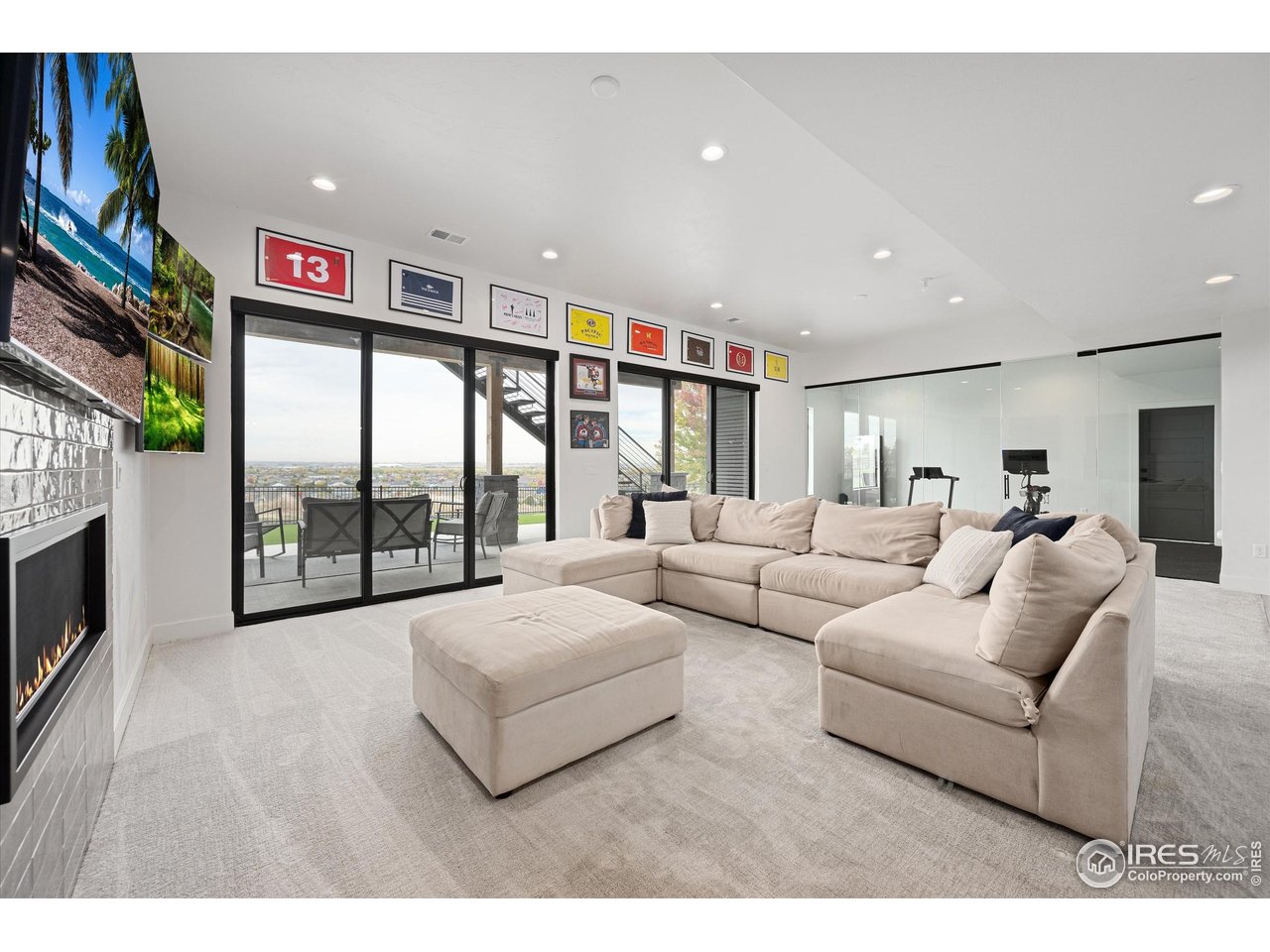 2145 Picture Point Drive Windsor, CO 80550 - Photo 27 of 40 a living room with furniture large window and a flat screen tv
