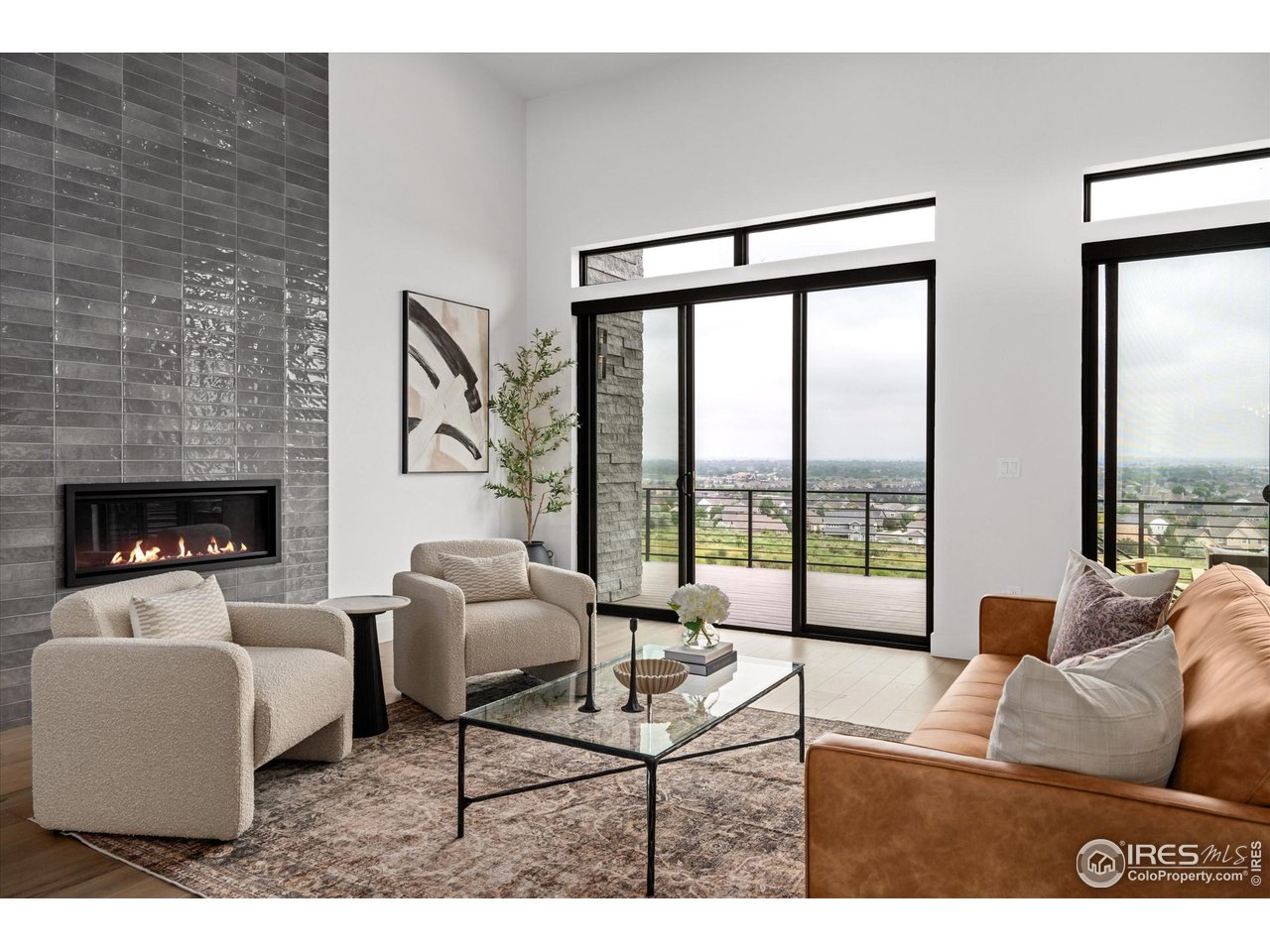 2145 Picture Point Drive Windsor, CO 80550 - Photo 3 of 40 a living room with furniture and a floor to ceiling window