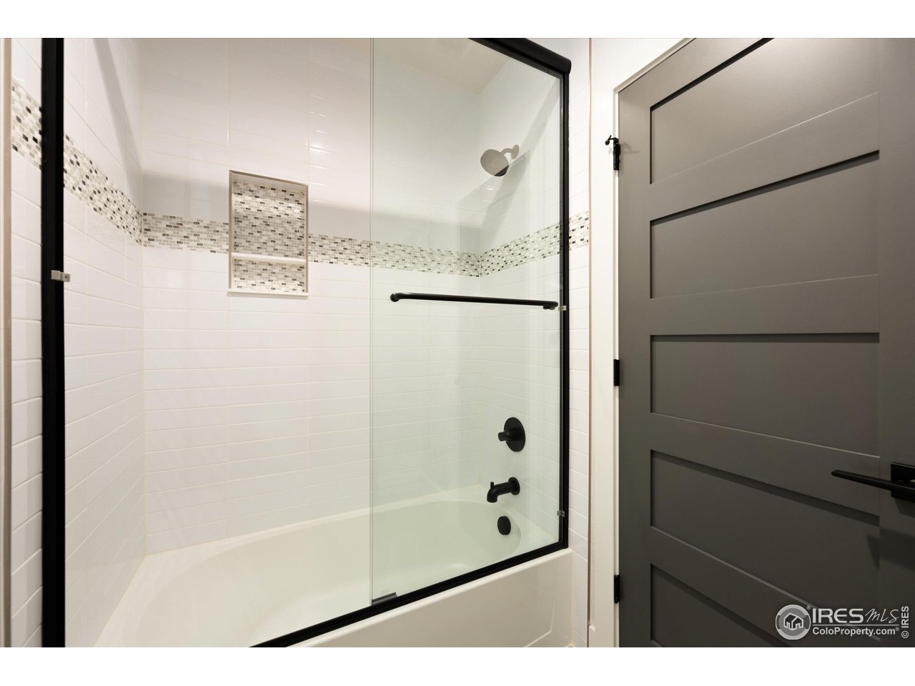 2145 Picture Point Drive Windsor, CO 80550 - Photo 34 of 40 a bathroom with a glass shower door