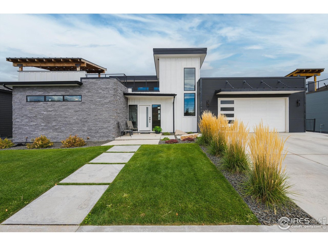 2145 Picture Point Drive Windsor, CO 80550 - Photo 36 of 40 a front view of a house with a yard and a garage