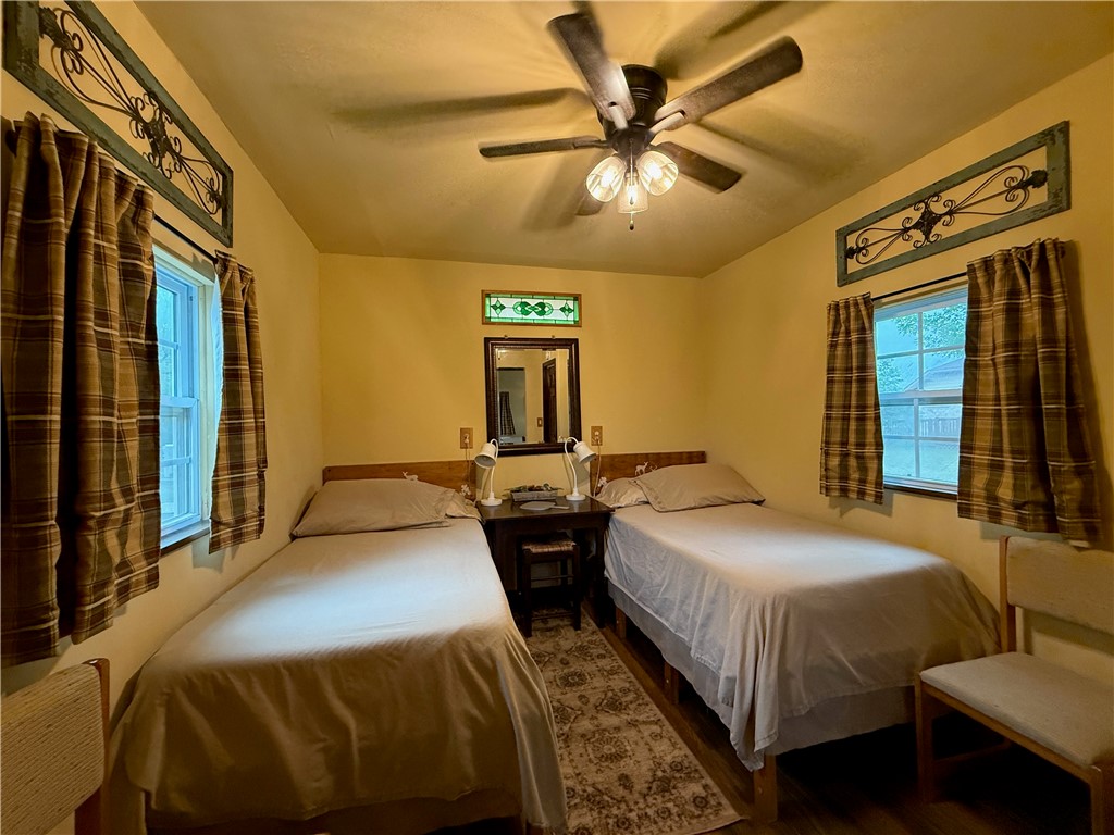 28799 Highway 83 Concan, TX 78838 - Photo 11 of 40 a bedroom with two beds and a chandelier