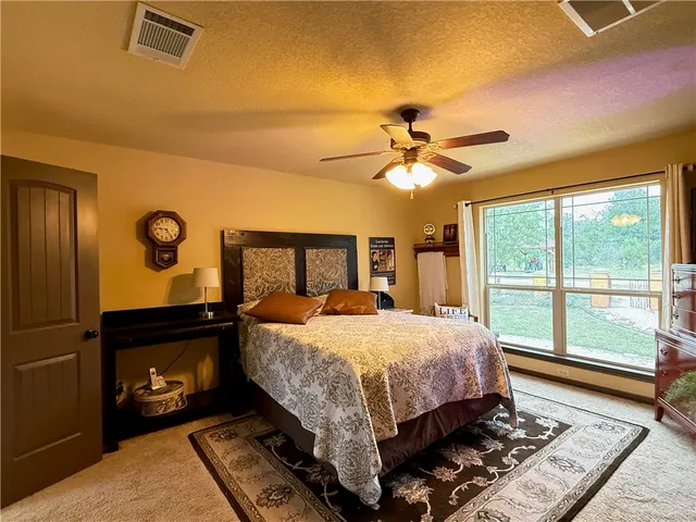 a bed sitting in a bedroom next to a window