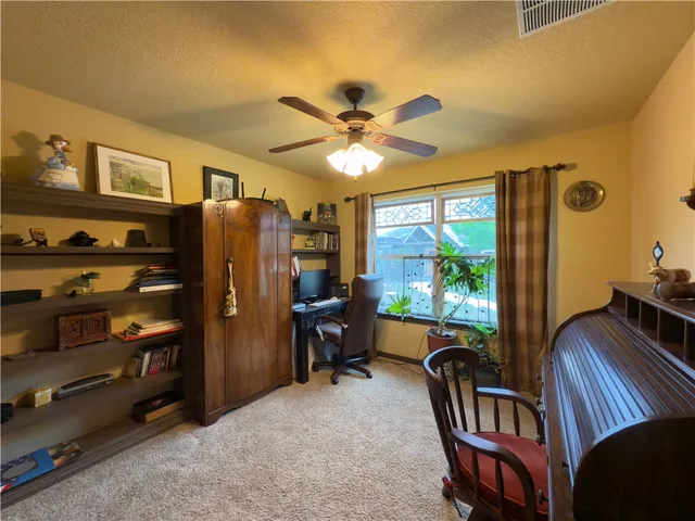 a workspace with furniture and a window