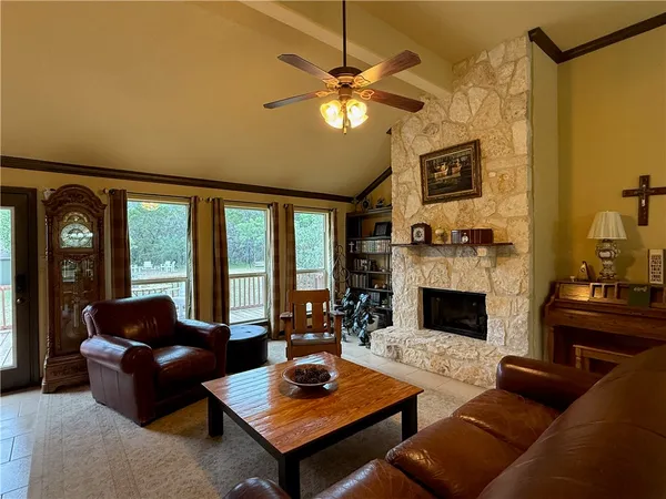 a living room with furniture fireplace and flat screen tv