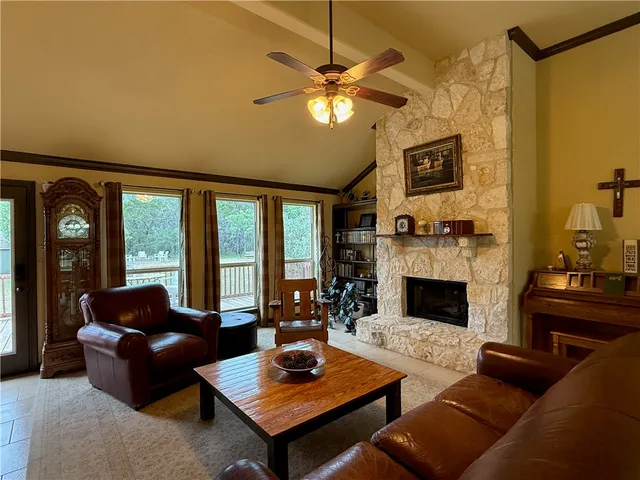 a living room with furniture fireplace and flat screen tv