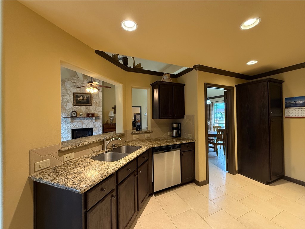 28799 Highway 83 Concan, TX 78838 - Photo 31 of 40 a kitchen with granite countertop a sink and cabinets