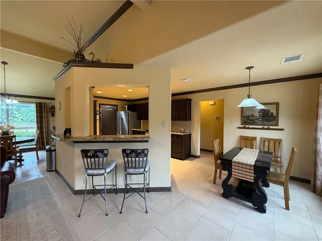 a living room with furniture a rug and chairs