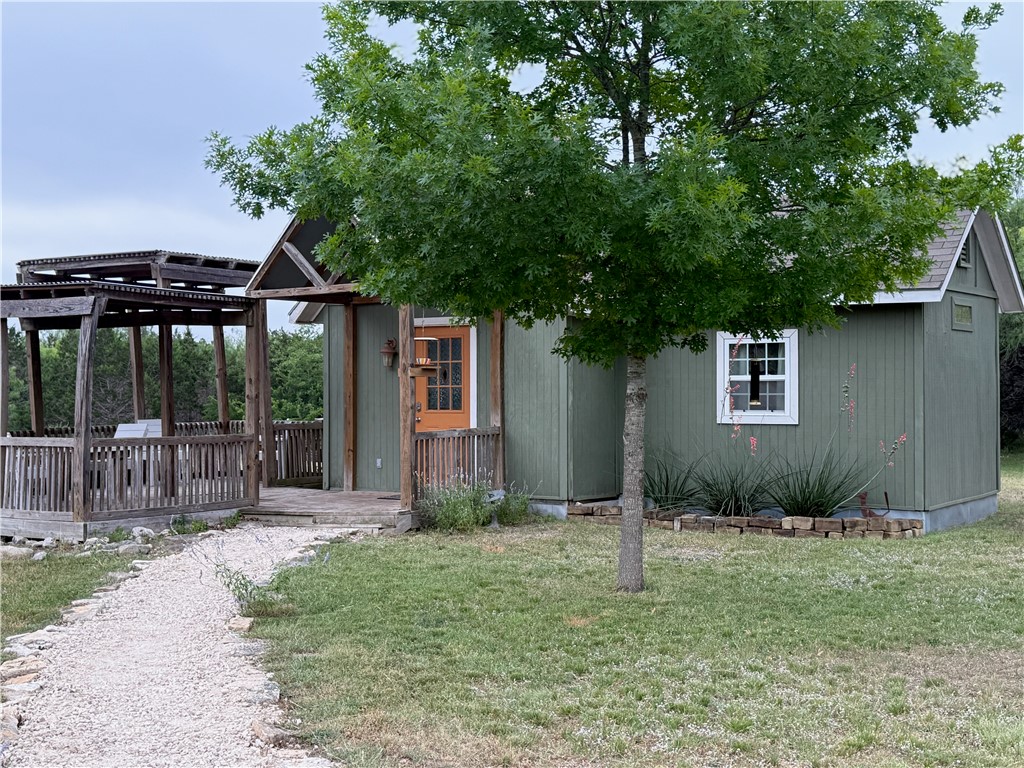 28799 Highway 83 Concan, TX 78838 - Photo 6 of 40 a front view of a house with garden