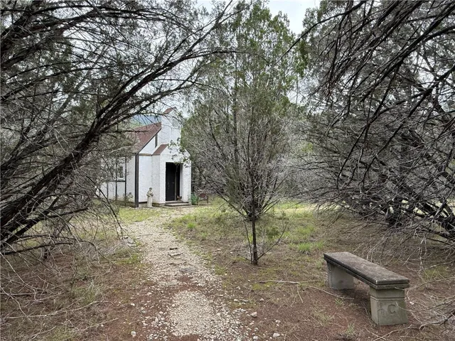 a yellow house sitting in middle of forest