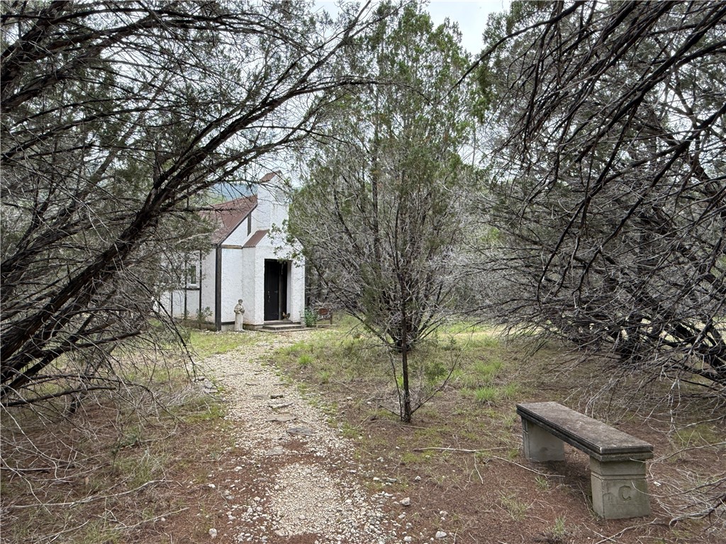 28799 Highway 83 Concan, TX 78838 - Photo 9 of 40 a yellow house sitting in middle of forest