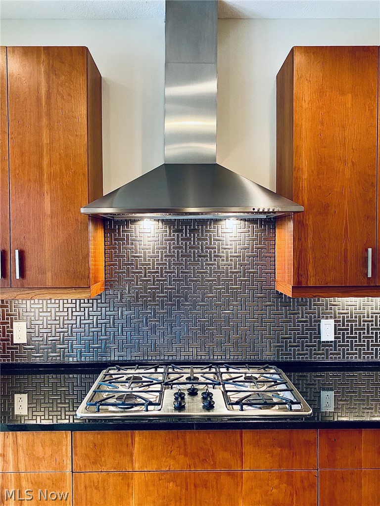12480 Cedar Road, Unit 14 Cleveland, OH 44106 - Photo 9 of 35 Gas cooktop with canopy hood and stainless steel tile backsplash