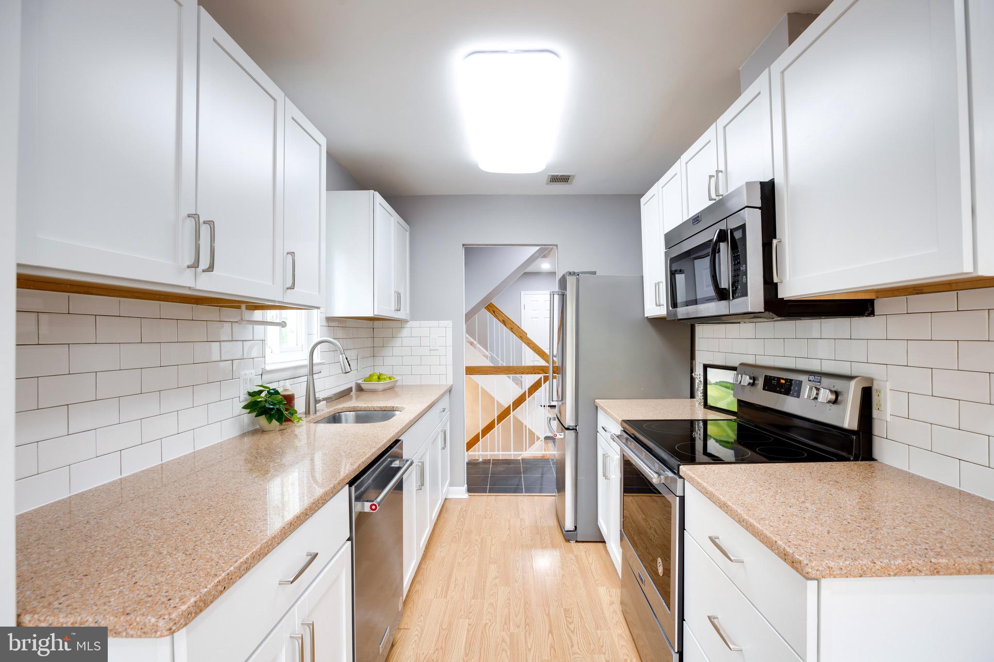 2318 Millennium Lane Reston, VA 20191 - Photo 11 of 34 a kitchen that has a lot of cabinets in it