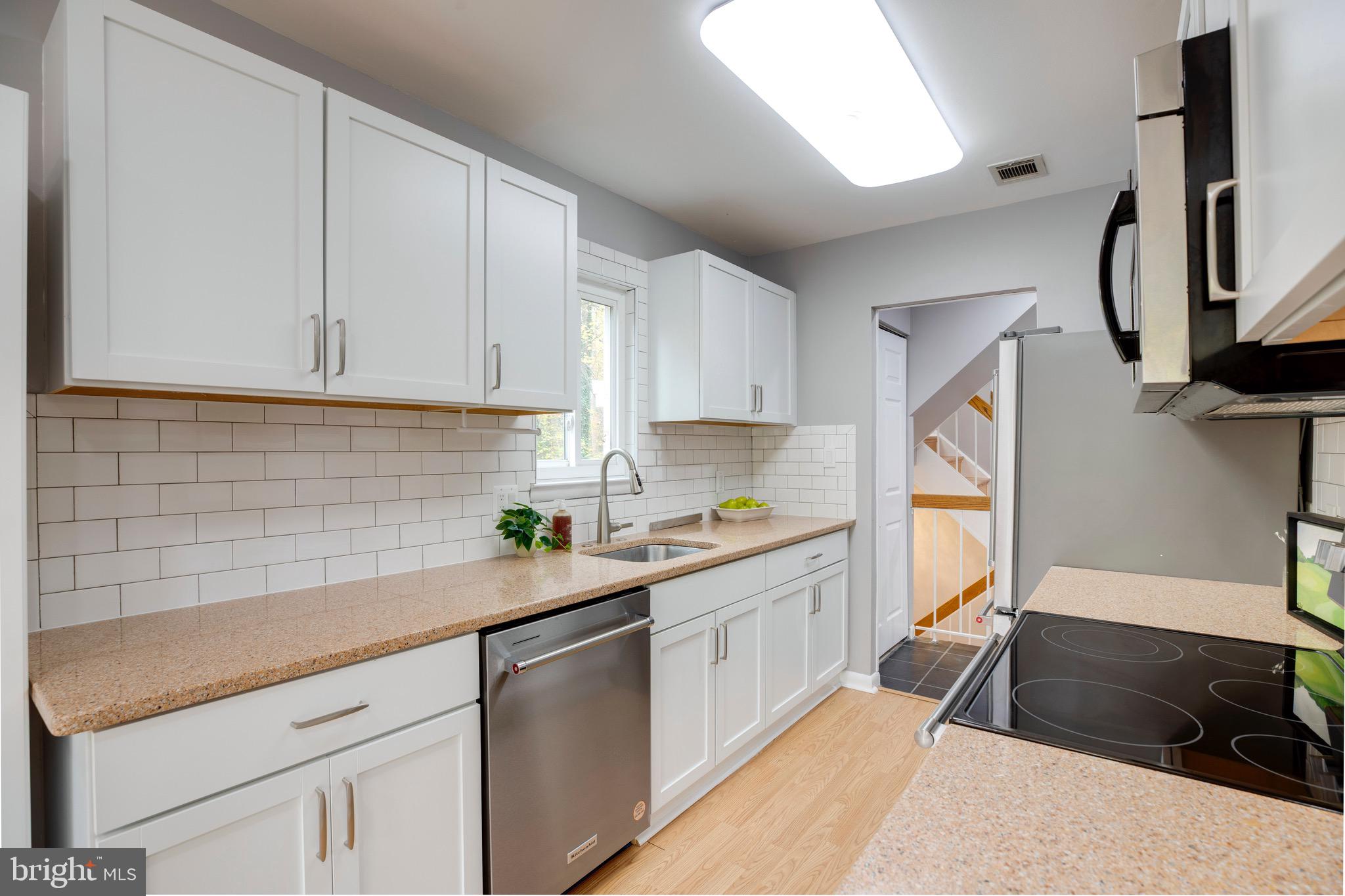 2318 Millennium Lane Reston, VA 20191 - Photo 12 of 34 a kitchen with a sink stove and cabinets
