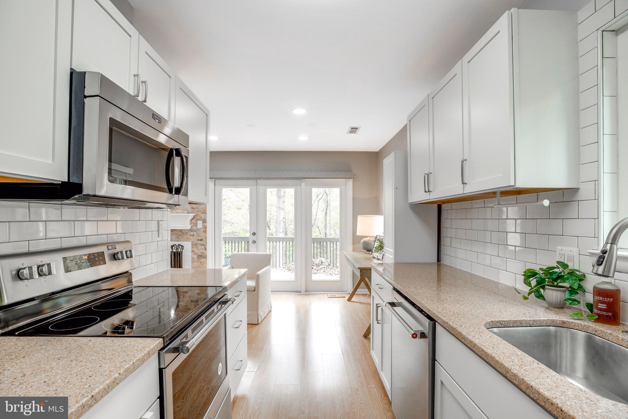 2318 Millennium Lane Reston, VA 20191 - Photo 13 of 34 a kitchen with a sink stove and microwave