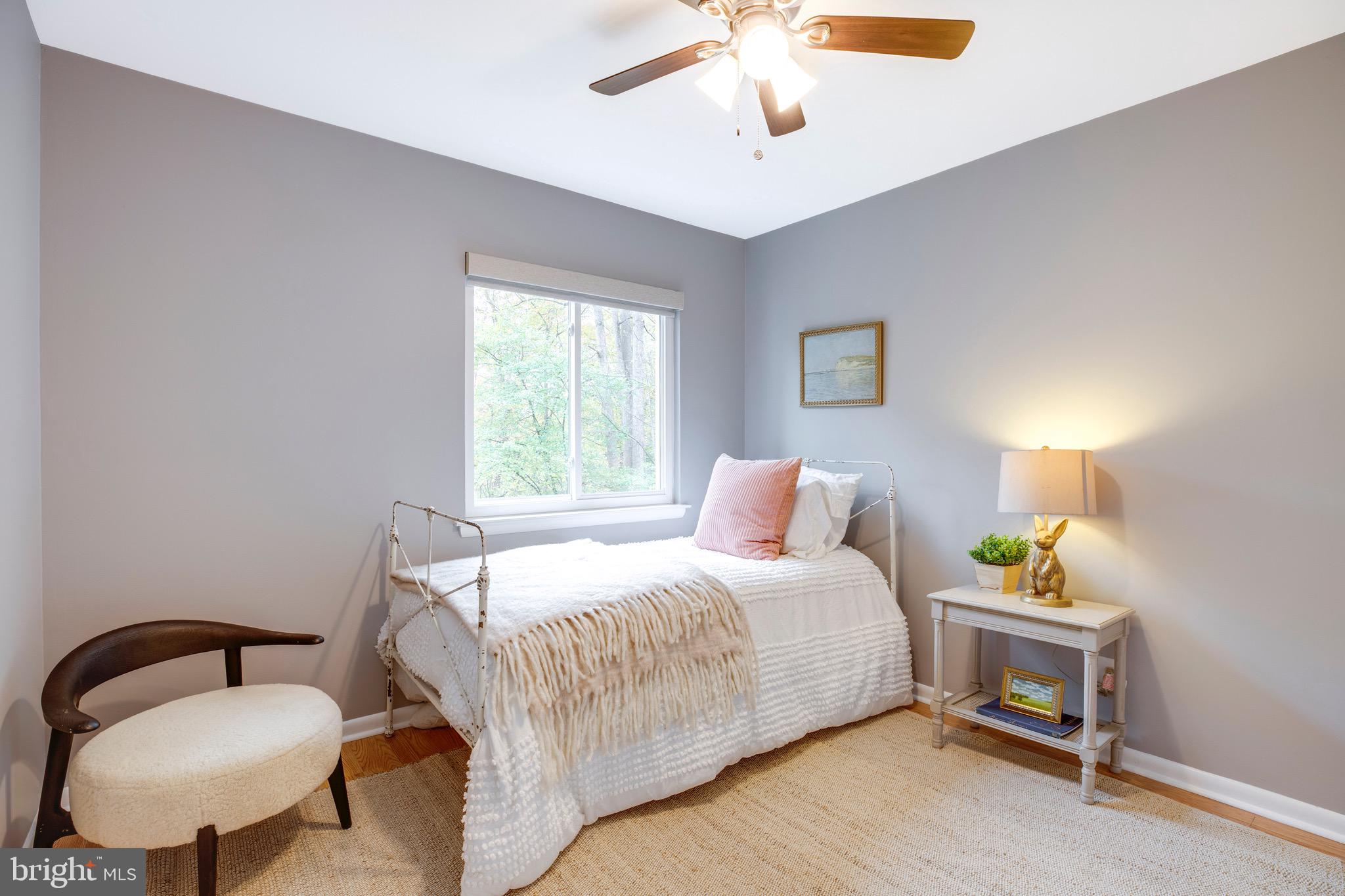 2318 Millennium Lane Reston, VA 20191 - Photo 17 of 34 a bedroom with a bed and a chandelier