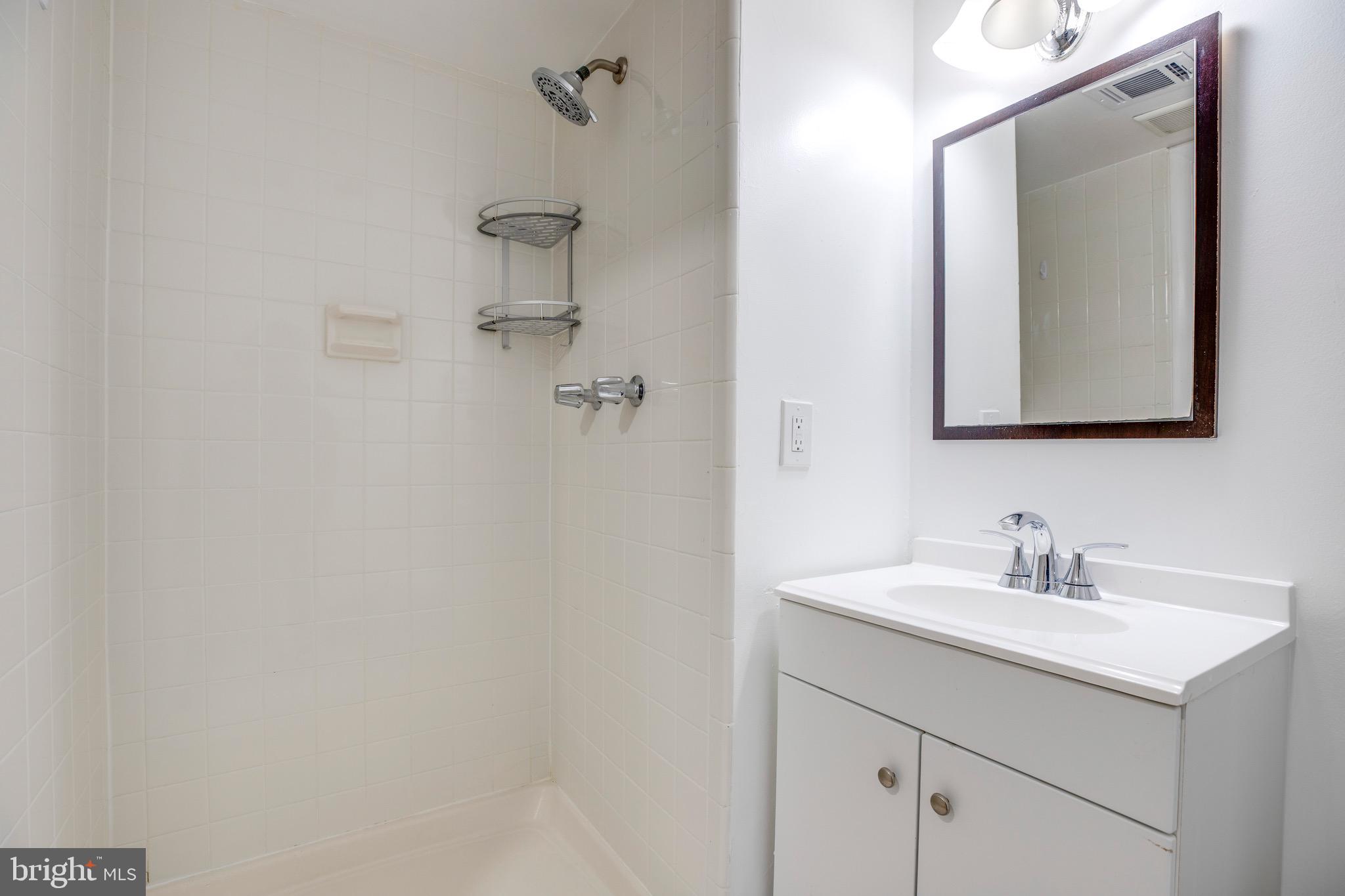 2318 Millennium Lane Reston, VA 20191 - Photo 30 of 34 a bathroom with a double vanity sink and a mirror
