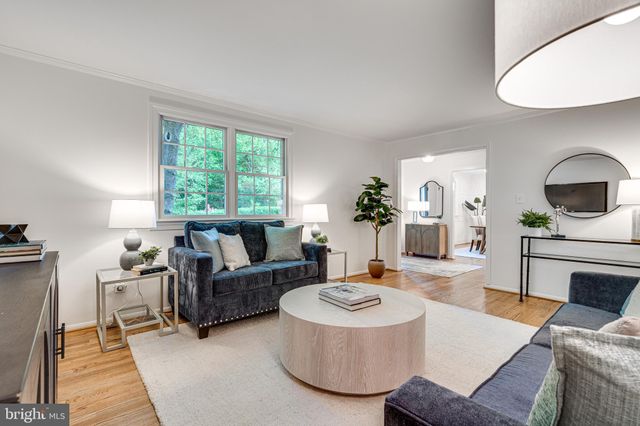 a living room with furniture a fireplace and a large window