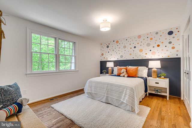 a bathroom with a granite countertop sink a toilet and a mirror