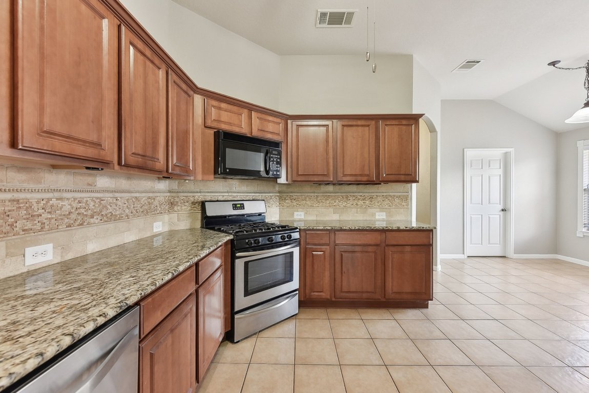 217 Newport Landing Place Round Rock, TX 78665 - Photo 11 of 30 Kitchen opens to Dining Space