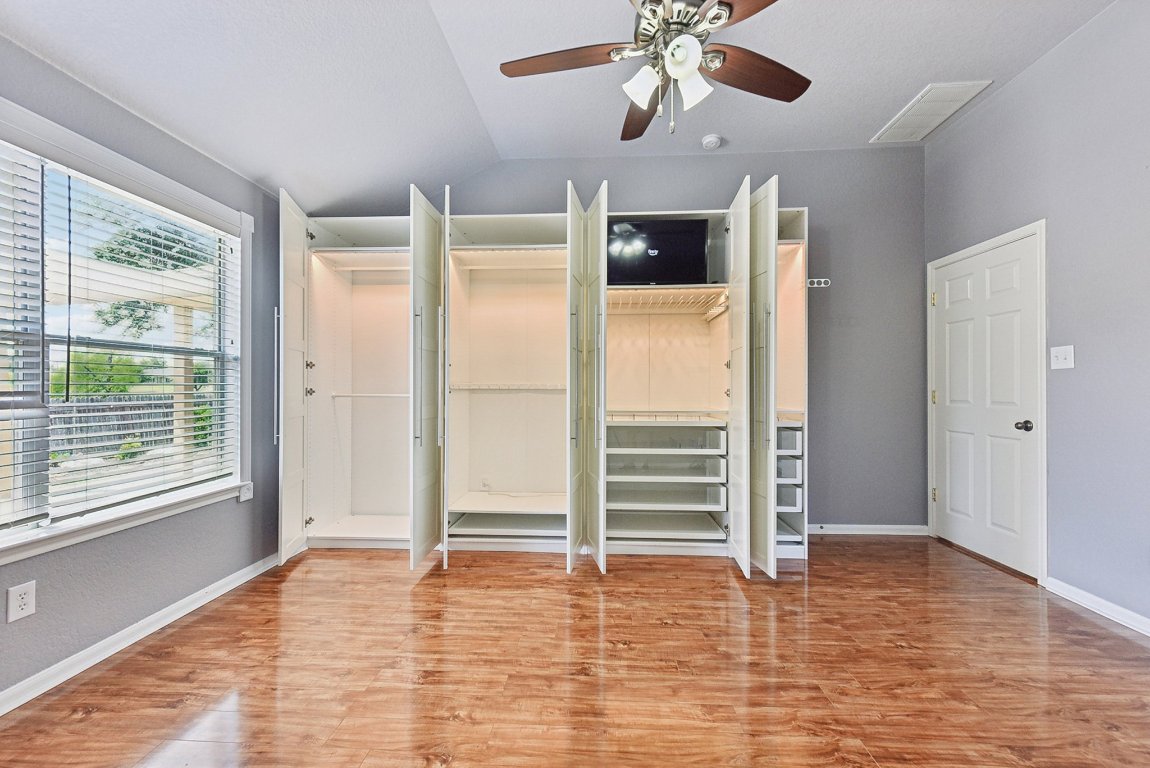 217 Newport Landing Place Round Rock, TX 78665 - Photo 17 of 30 Plenty of additional closet space with the custom cabinetry and TV space.