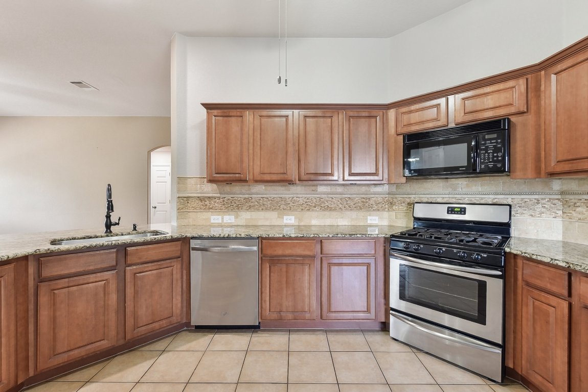 217 Newport Landing Place Round Rock, TX 78665 - Photo 10 of 30 Kitchen conveniently opens up to living room