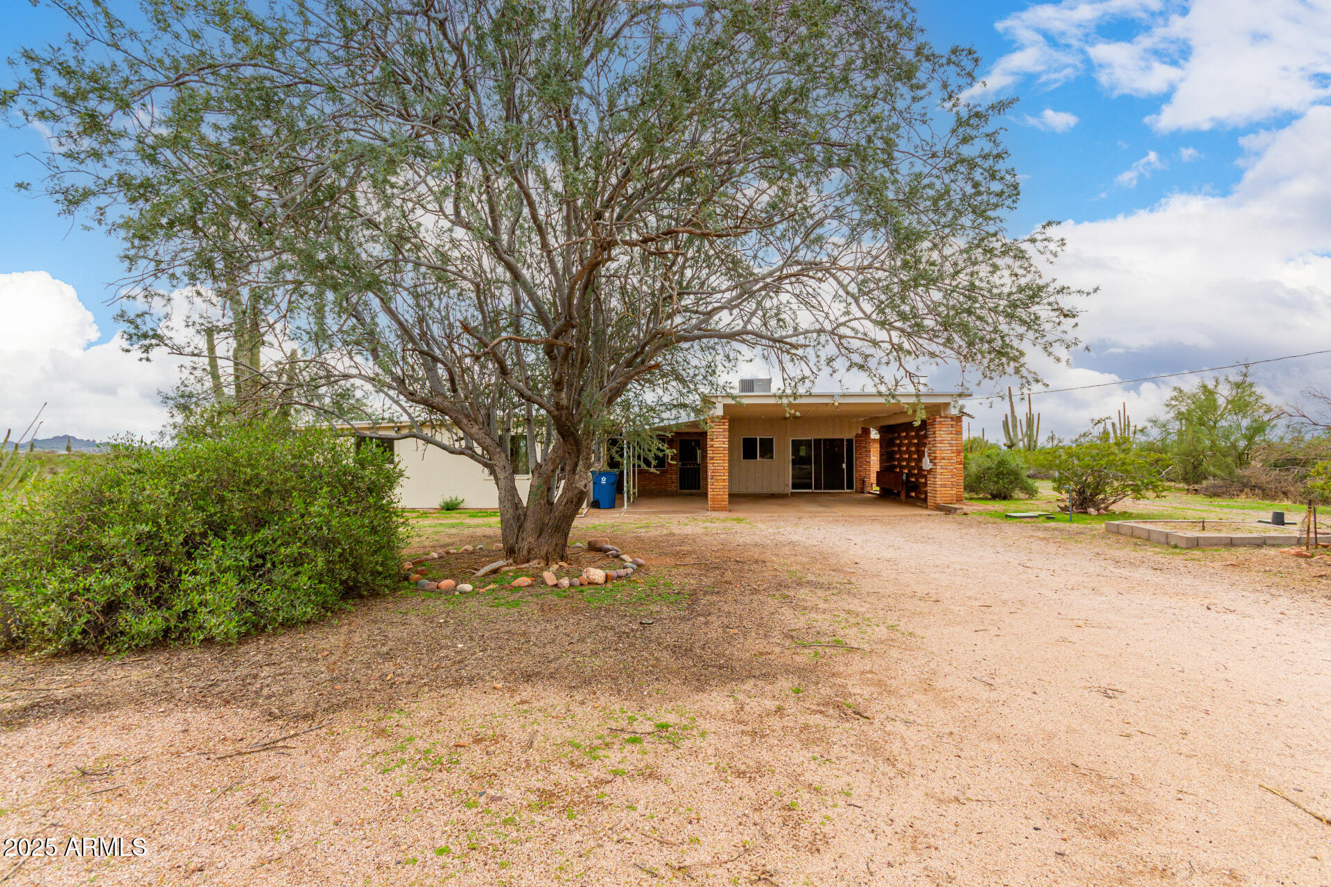 1126 North Goldfield Road Apache Junction, AZ 85119 - Photo 6 of 14 a front view of a house with a yard and garage