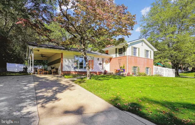 a view of a hallway with wooden floor and a livingroom