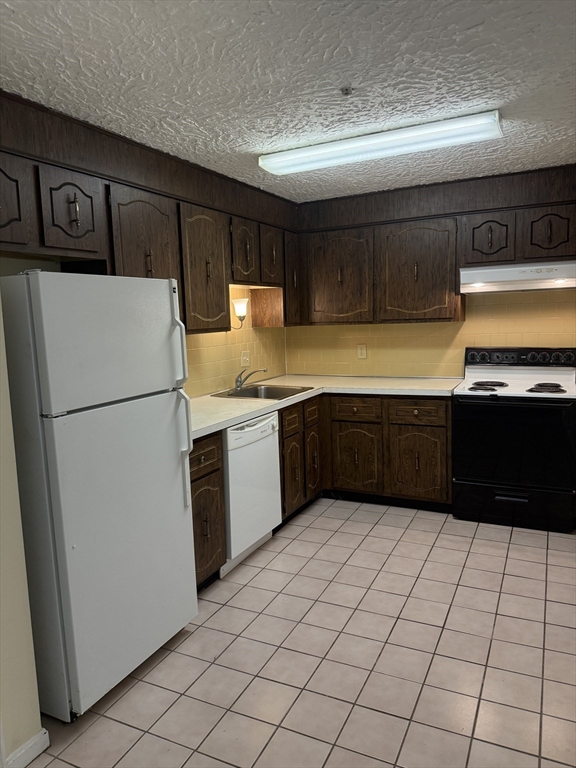 310 Codman Hill Road, Unit 34D Boxborough, MA 01719 - Photo 17 of 17 a kitchen with stainless steel appliances granite countertop a refrigerator and a sink