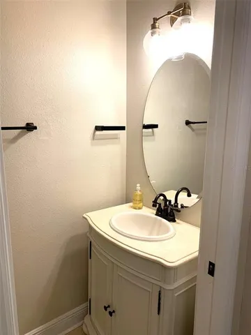 a bathroom with a sink and mirror