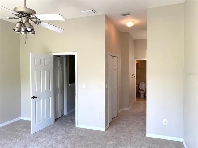 a view of a chandelier fan and refrigerator in a room