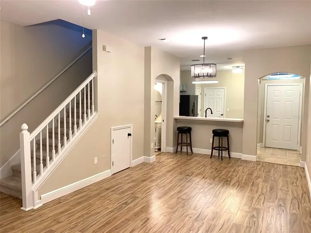 a view of a room with wooden floor and staircase