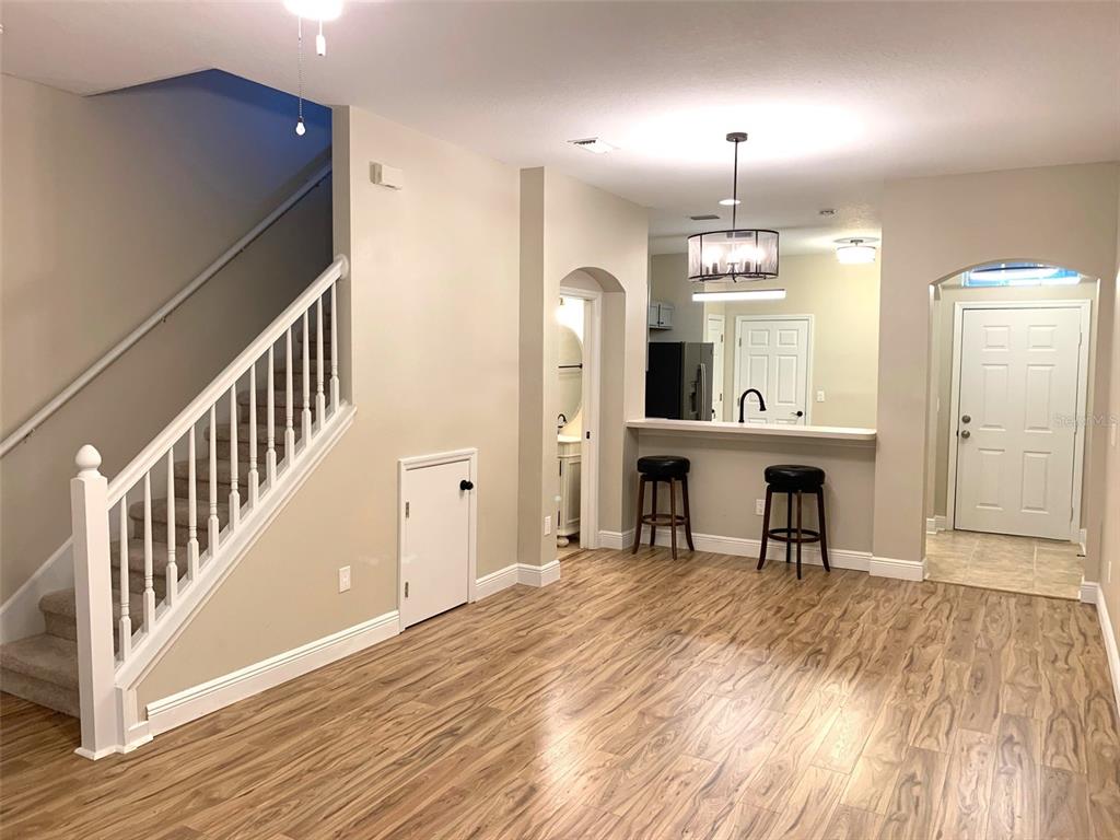 11106 Windsor Pl Circle Tampa, FL 33626 - Photo 4 of 24 a view of a room with wooden floor and staircase