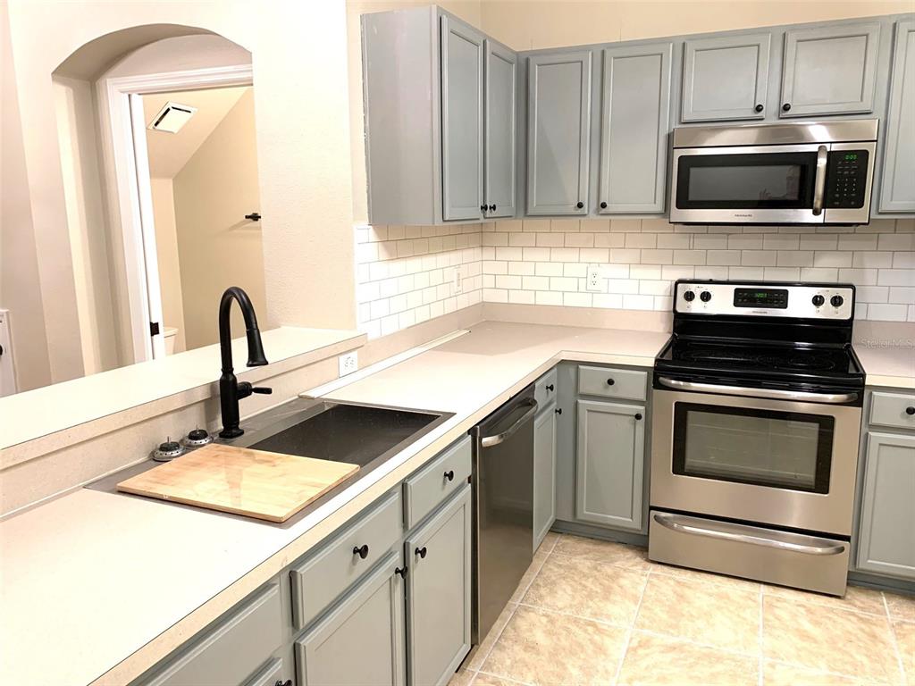11106 Windsor Pl Circle Tampa, FL 33626 - Photo 7 of 24 a kitchen with a sink and steel appliances