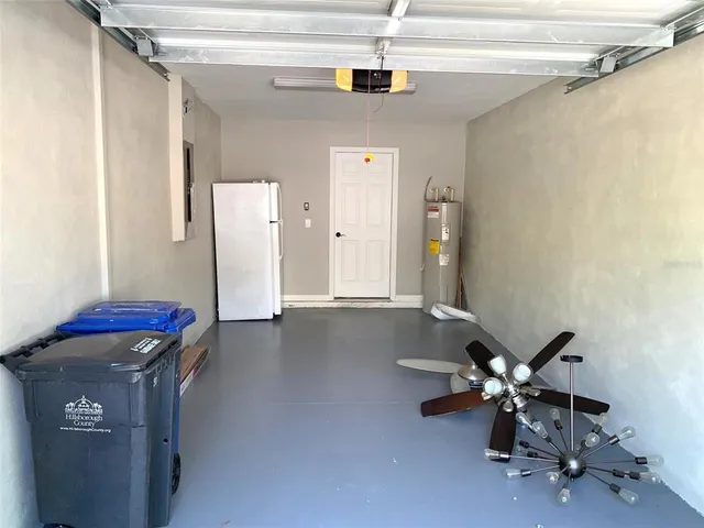 a view of a livingroom with chairs and a ceiling fan