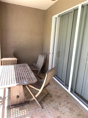 a view of a room with furniture and a window