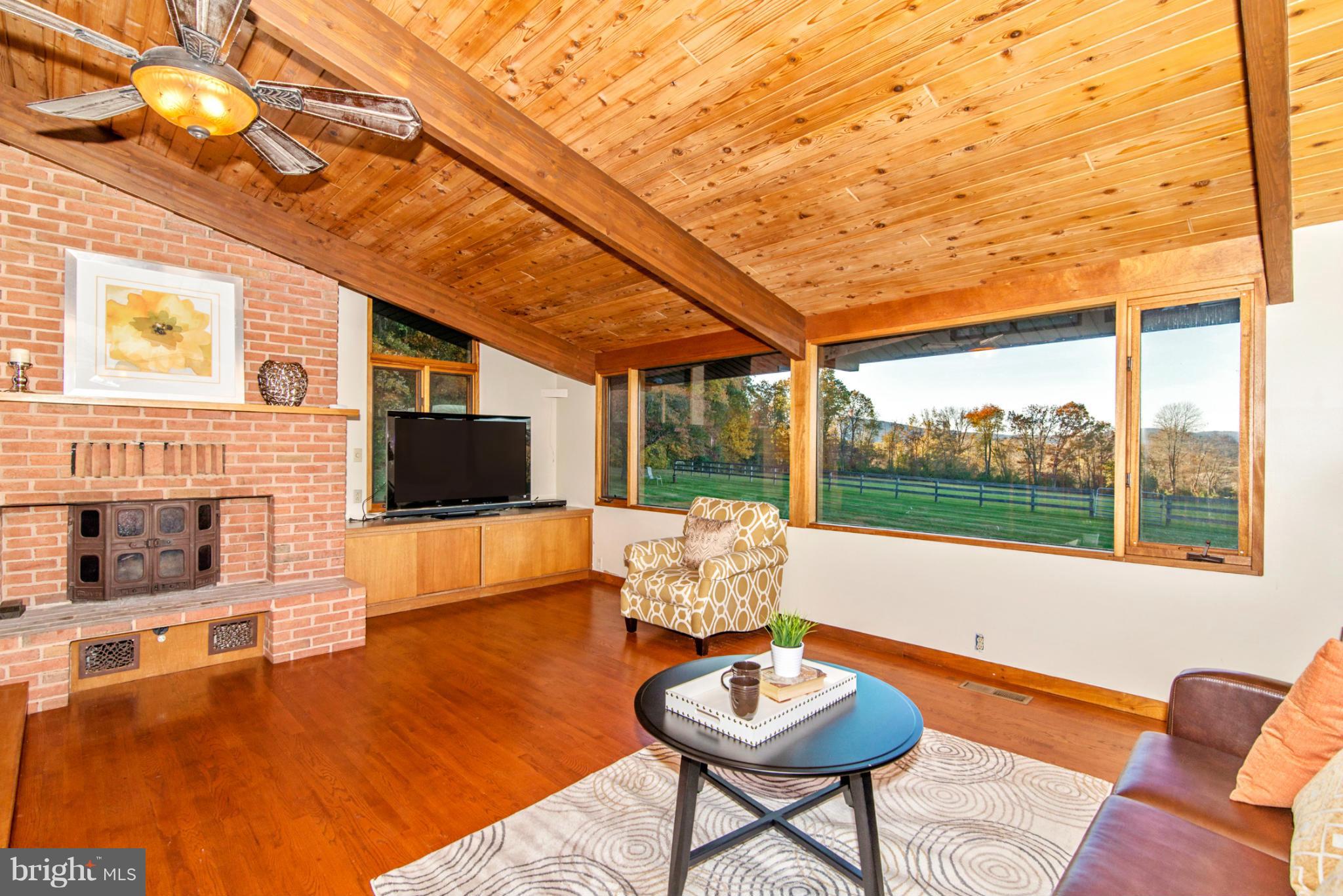 3160 Sumantown Road Middletown, MD 21769 - Photo 16 of 25 a living room with furniture a flat screen tv and a large window