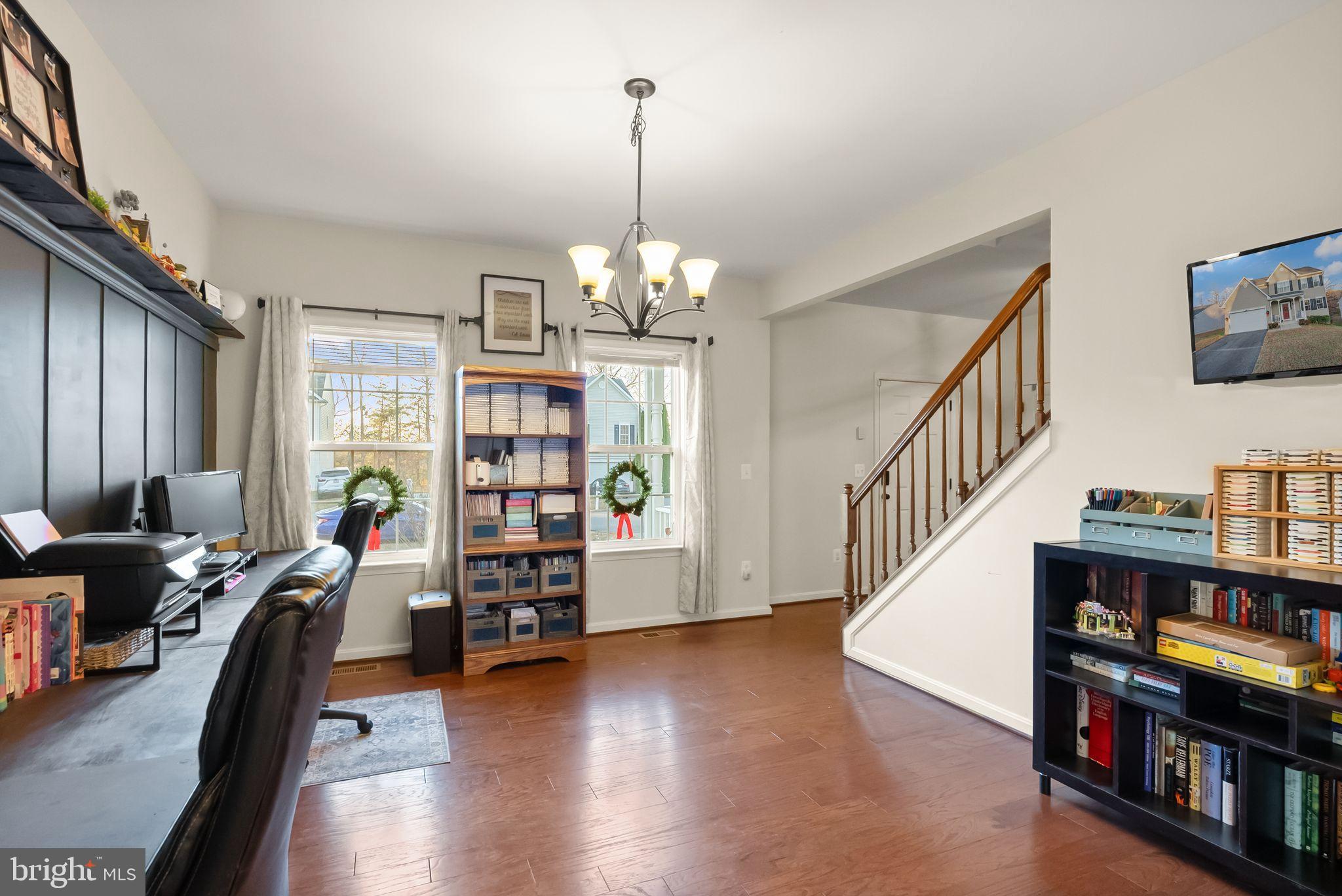2219 Wildflower Way Locust Grove, VA 22508 - Photo 12 of 49 a living room with lots of furniture and a book shelf