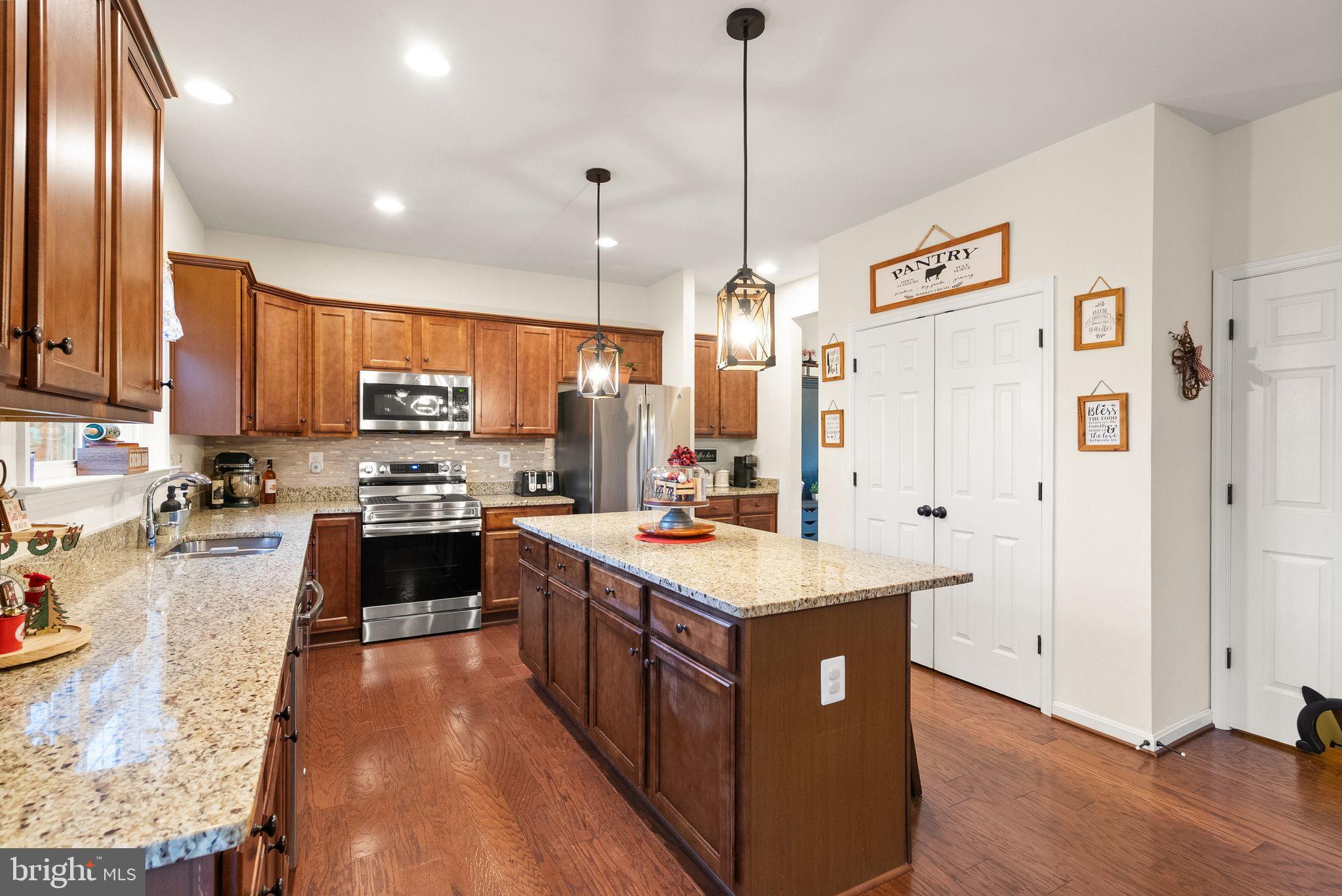 2219 Wildflower Way Locust Grove, VA 22508 - Photo 15 of 49 a kitchen with stainless steel appliances a sink stove and refrigerator