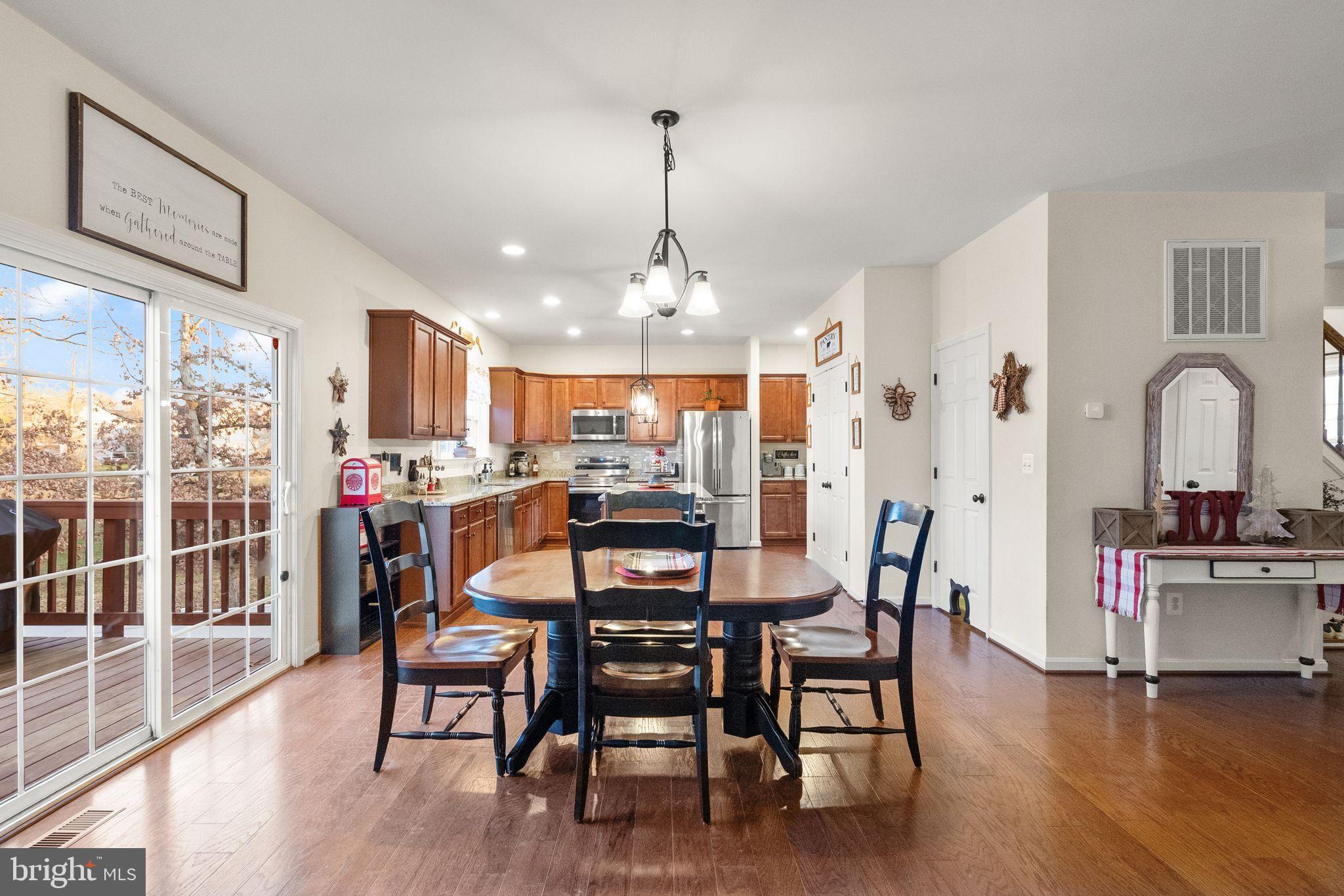 2219 Wildflower Way Locust Grove, VA 22508 - Photo 19 of 49 a view of a dining room with furniture window and wooden floor