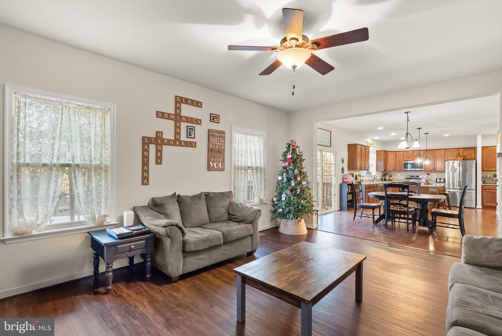 2219 Wildflower Way Locust Grove, VA 22508 - Photo 22 of 49 a living room with furniture kitchen view and a large window