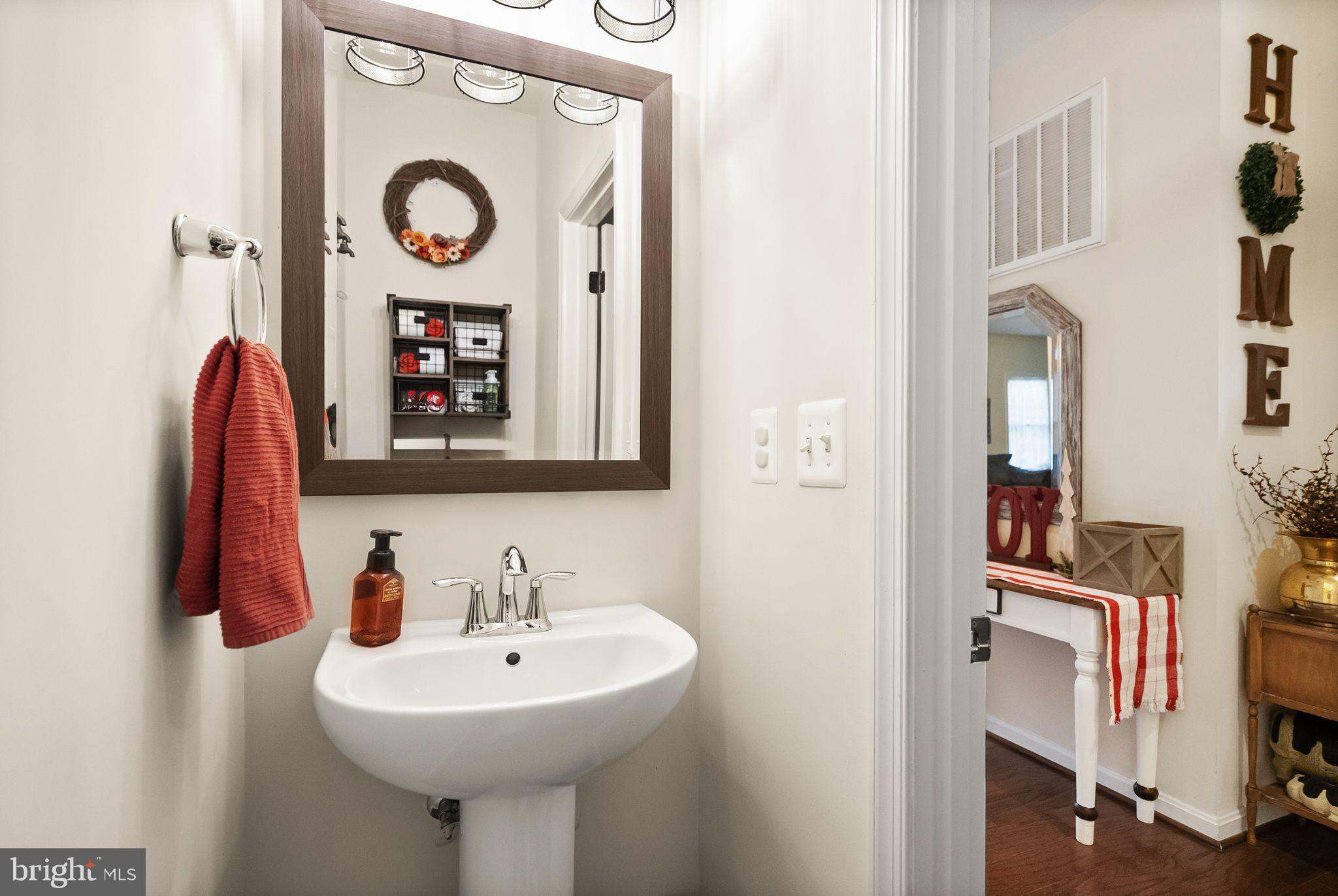 2219 Wildflower Way Locust Grove, VA 22508 - Photo 23 of 49 a bathroom with a sink and a mirror