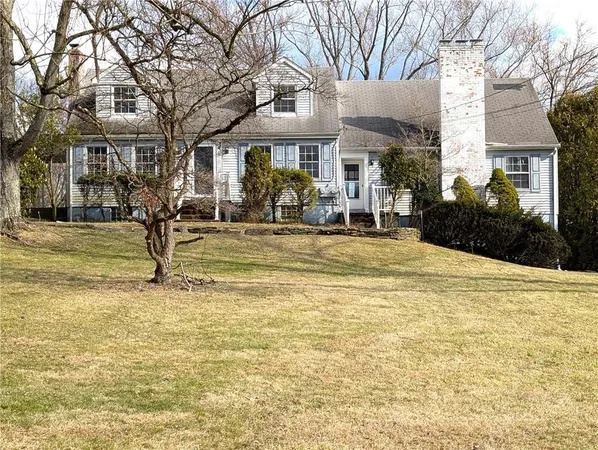 a front view of a building with a garden