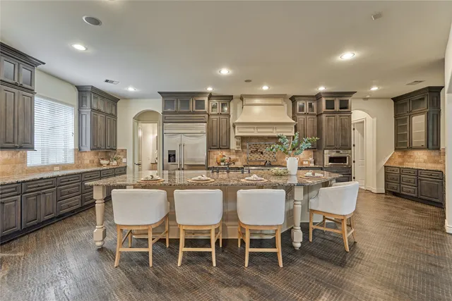 a large kitchen with a table and chairs