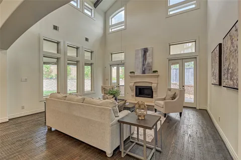 a living room with fireplace furniture and a wooden floor