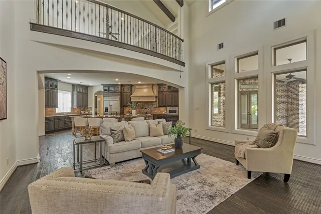 a living room with furniture wooden floor and a table