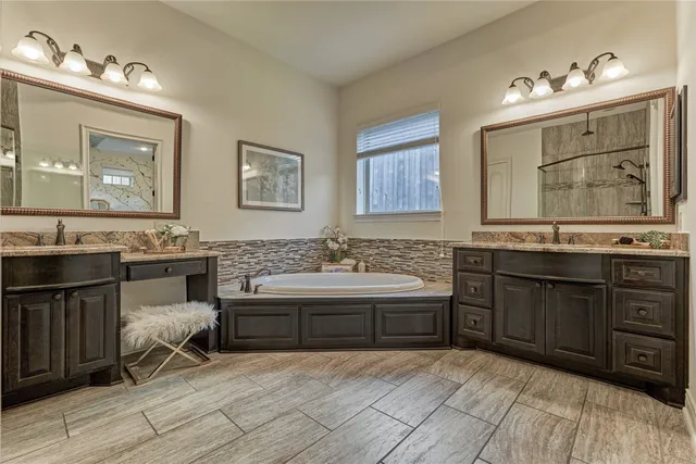 a spacious bathroom with a granite countertop sink and a mirror