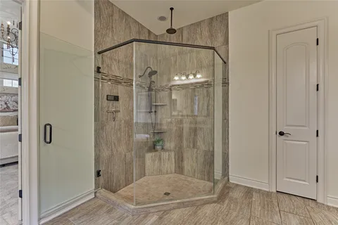 a bathroom that has a glass shower door